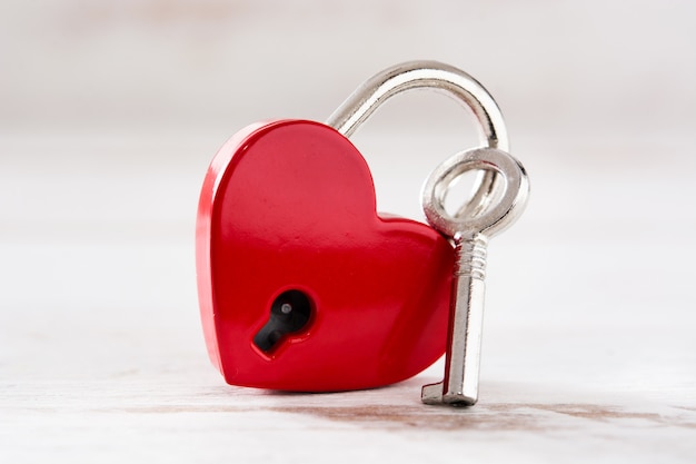 Premium Photo | Red padlock hearts with key on white wooden background