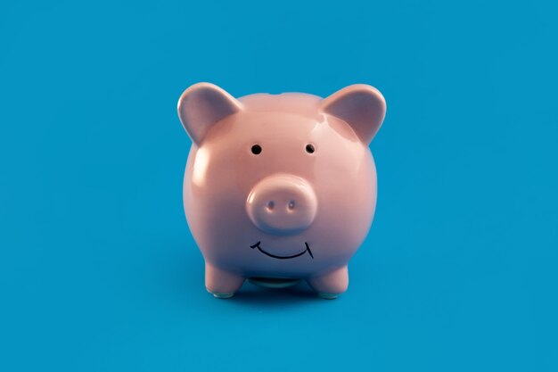 Premium Photo | Red piggy bank on blue background