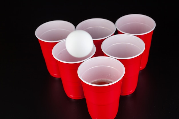 Premium Photo Red Plastic Cups And Ball For Game Of Beer Pong