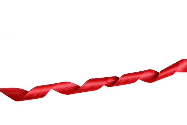 Premium Photo | Red ribbon twisted in a spiral on a white background.