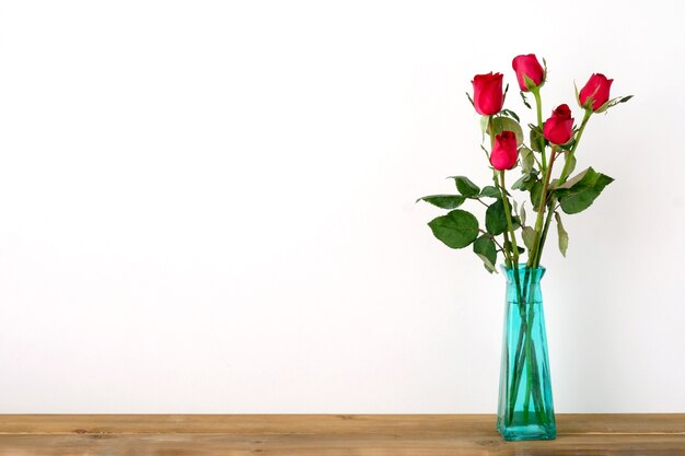 Premium Photo | Red roses flower bouquet in green vase on white background