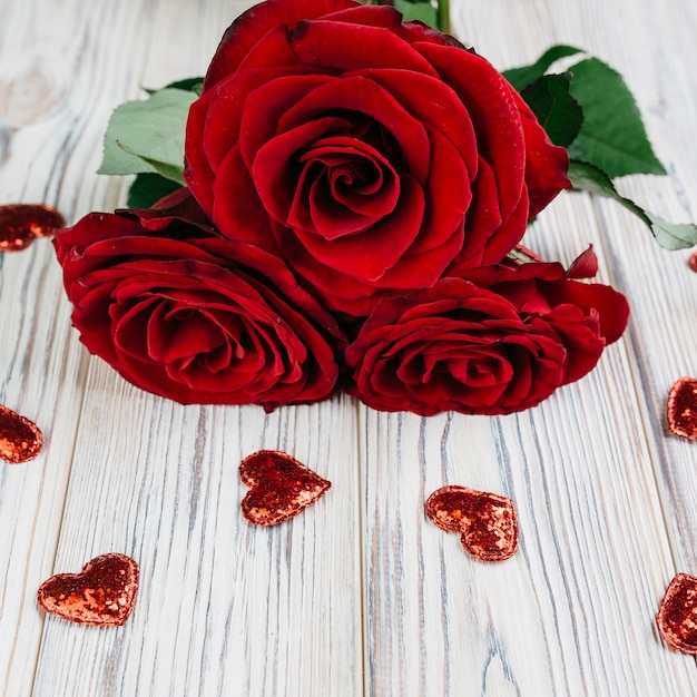 Free Photo Red Roses With Small Hearts On Table