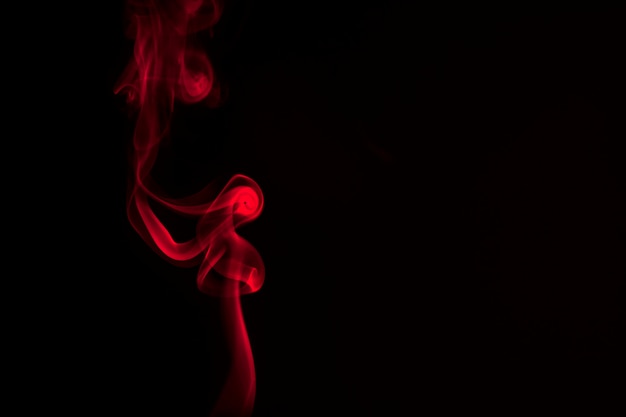 Premium Photo | Red smoke on a black background.