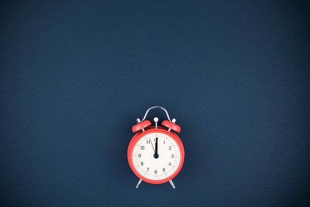 Premium Photo | Red vintage alarm clock on dark background