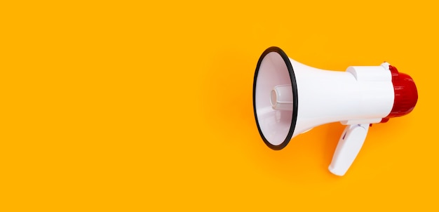 Premium Photo | Red and white megaphone on orange background.