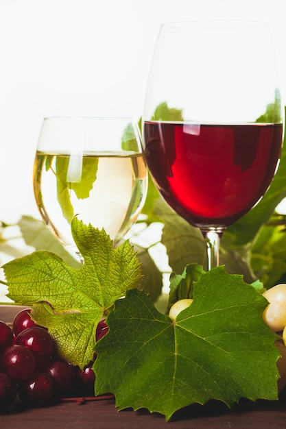 Premium Photo | Red and white wine in glass over wooden table