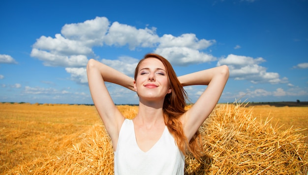 Premium Photo | Redhead girl lying down on hay