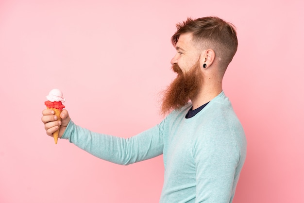 Premium Photo Redhead Man With Long Beard Holding A Cornet Ice Cream