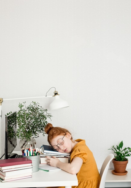 A Redheaded Girl Fell Asleep While Studying Premium Photo