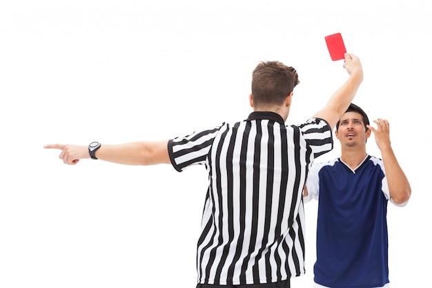 Premium Photo | Referee sending off football player