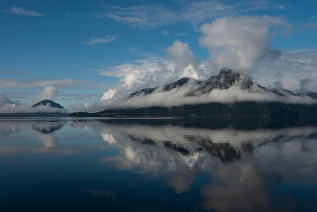 Premium Photo | Reflection of mountain in water, furry creek, british ...