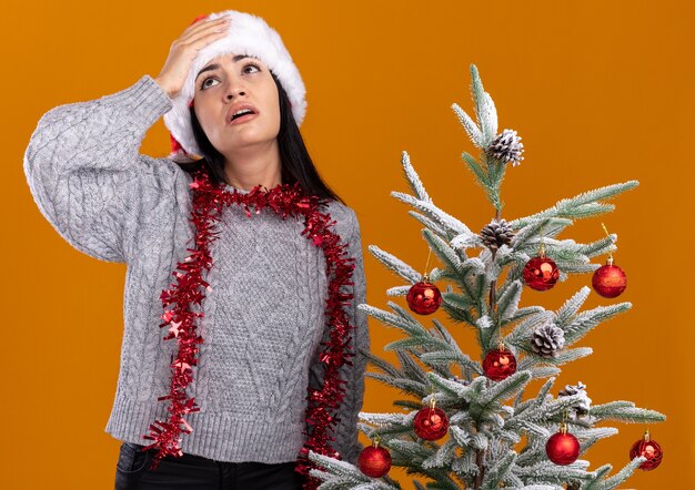 Free Photo | Regretting young caucasian girl wearing christmas hat and ...