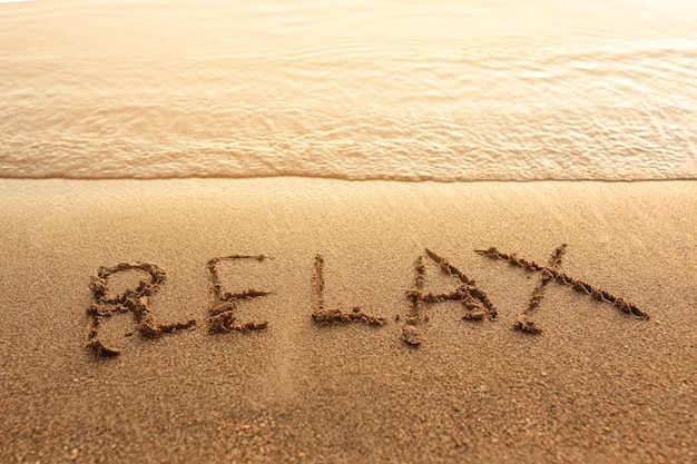 Relax written on sand Photo | Free Download