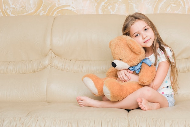 girl hugging a teddy bear