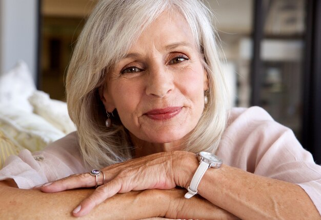 Premium Photo Relaxed Older Woman Smiling And Sitting On Sofa