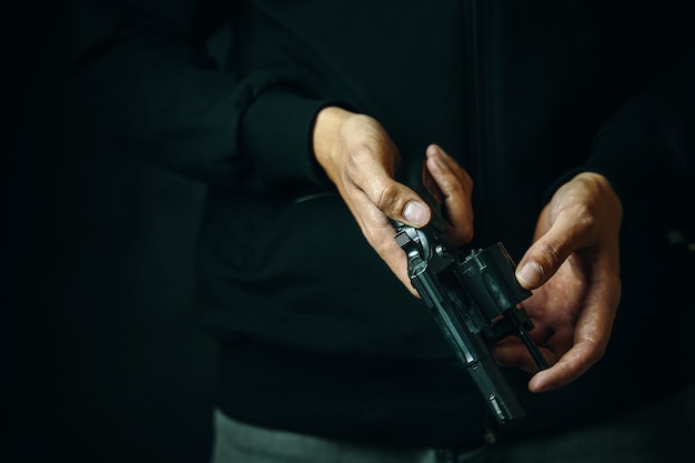Premium Photo | Reloading revolver closeup mens hands check for bullets ...