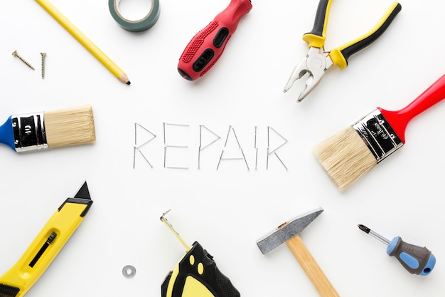 free-photo-repair-word-written-with-nails-and-repair-utensils