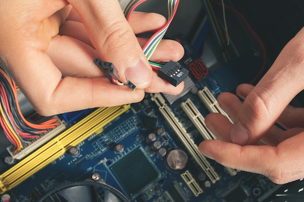 Premium Photo | The repairer connects the wires in the computer. repair ...