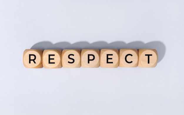 Premium Photo | Respect word on wooden blocks isolated on gray background