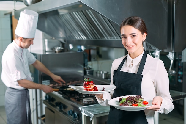 Premium Photo | Restaurant kitchen. waiter with a ready-made dish foie ...