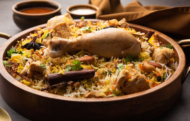 Premium Photo | Restaurant style spicy chicken biryani served with ...