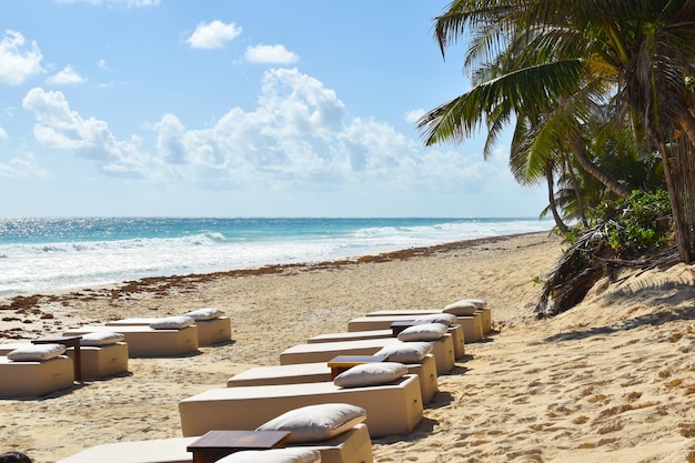 Premium Photo | Resting place on a tropical beach sun loungers in an ...