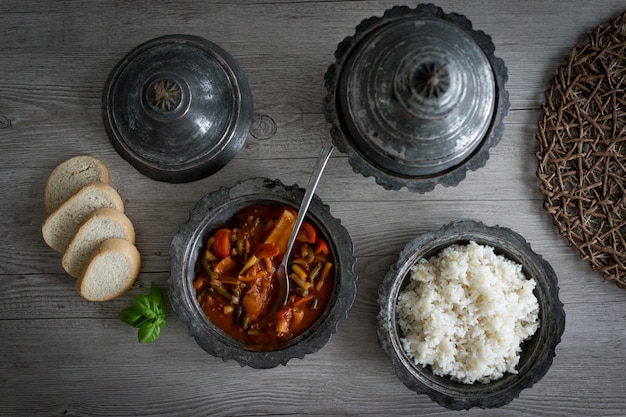 Retro silver utensil and plates with food Premium Photo