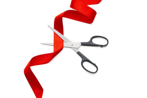 Ribbon with scissors isolated on white | Premium Photo