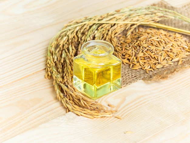 Premium Photo | Rice bran oil on wooden background. food and healthcare  concept.