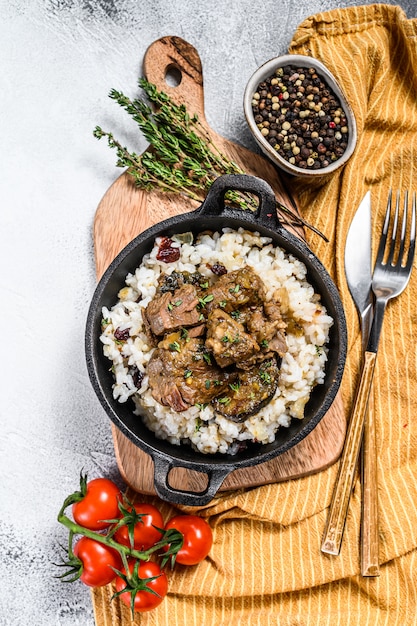 Premium Photo | Rice with stewed lamb meat in a skillet