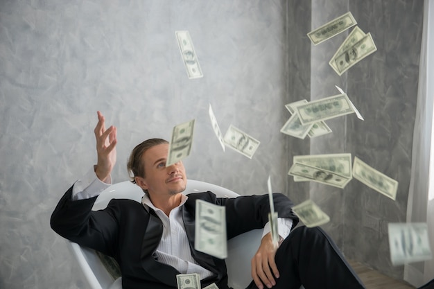 Premium Photo | Rich businessman lying in bathtub filled with dollar ...