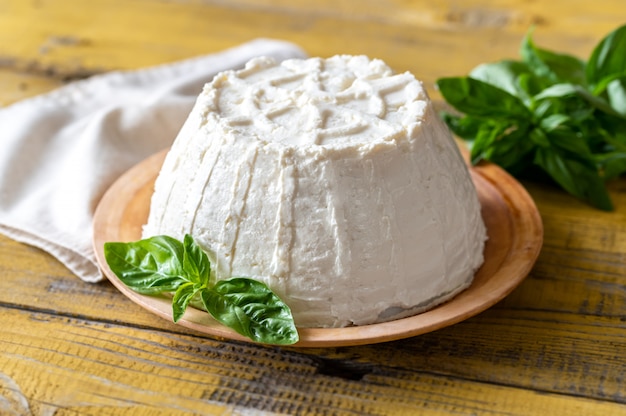 Frozen ricotta on a plate with fresh basil