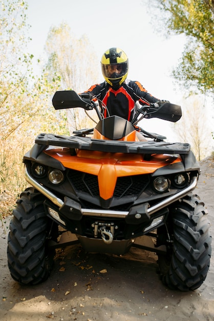 Premium Photo | Rider in helmet on quad bike, front view, closeup