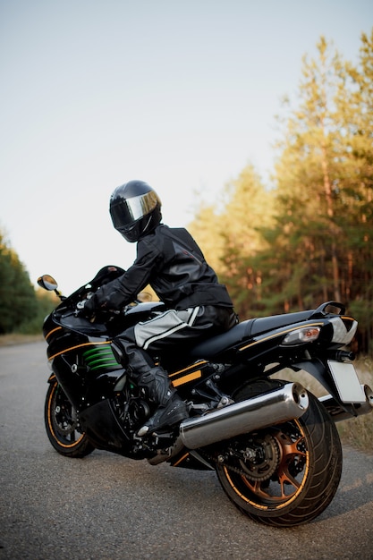 Premium Photo | Rider on a motorbike driving at sunset - space for your ...