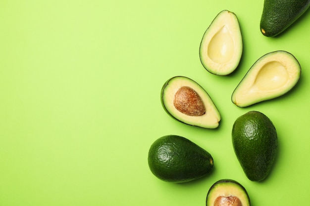 Premium Photo | Ripe fresh avocado on green background, top view