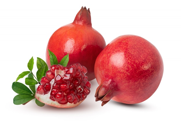 Ripe pomegranate fruits with leaves on the white background. with clipping path. Premium Photo