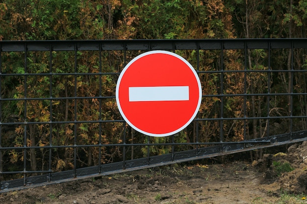 Premium Photo Road Sign Prohibition On A Metal Gate Over A Dark Forest