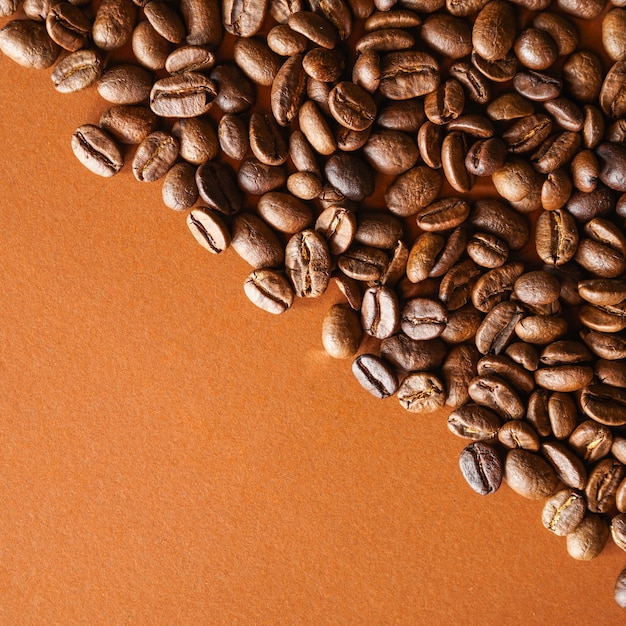 Premium Photo | Roasted coffee beans on brown background