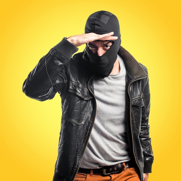 Premium Photo | Robber showing something on colorful background