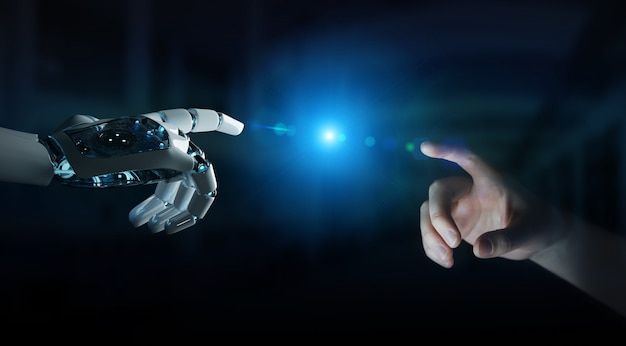 Robot hand making contact with human hand on dark background Premium Photo