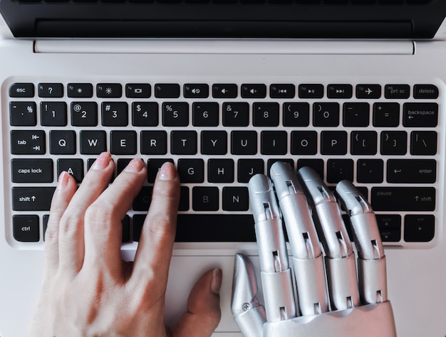 Robot hands and fingers point to laptop button advisor chatbot robotic artificial intelligence conce