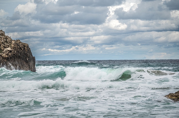 Premium Photo | Rock formations on beach against sky. beautiful ocean ...