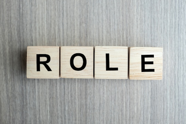 Role business word conceptual with wooden cubes block on table background Premium Photo