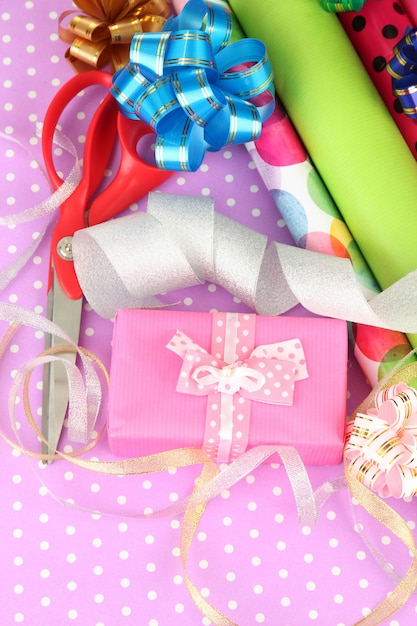 Premium Photo | Rolls of christmas wrapping paper with ribbons, bows on