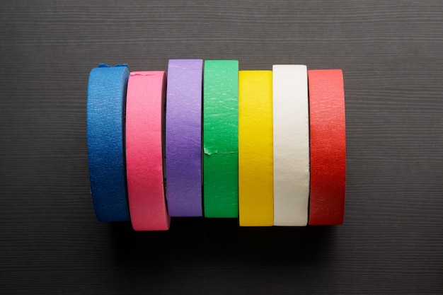 Premium Photo | Rolls of colored masking tape on dark wood ...