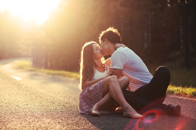 Romantic Couple Kissing On The Road At Sunset Photo Free Download