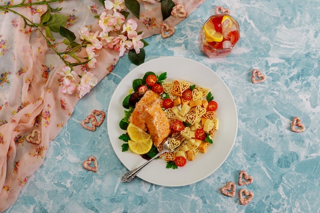 Premium Photo | Romantic dinner heart shape pasta, salmon and vegetable.