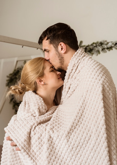 Free Photo Romantic Young Couple Covered With A Blanket