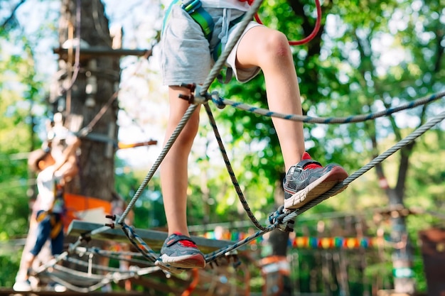 Premium Photo | Rope park. close - up of a child's feet passing an ...