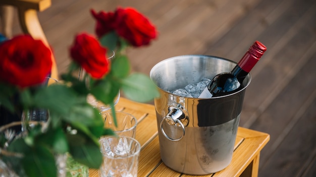 roses-wine-bottle-ice-bucket-table_23-2147891217.jpg